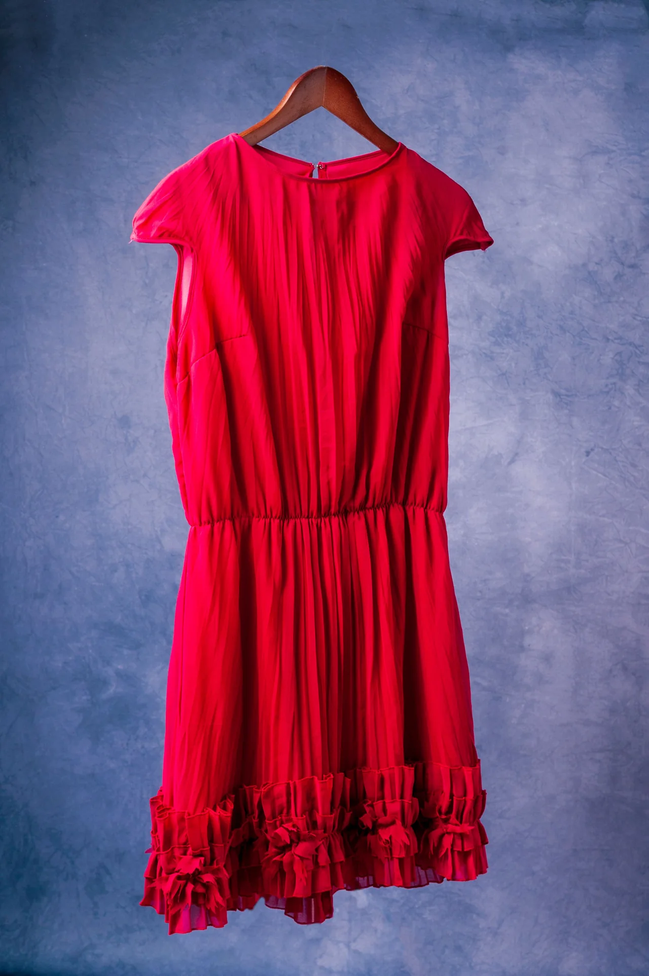 Real practice dress photographed on a hanger, back view
